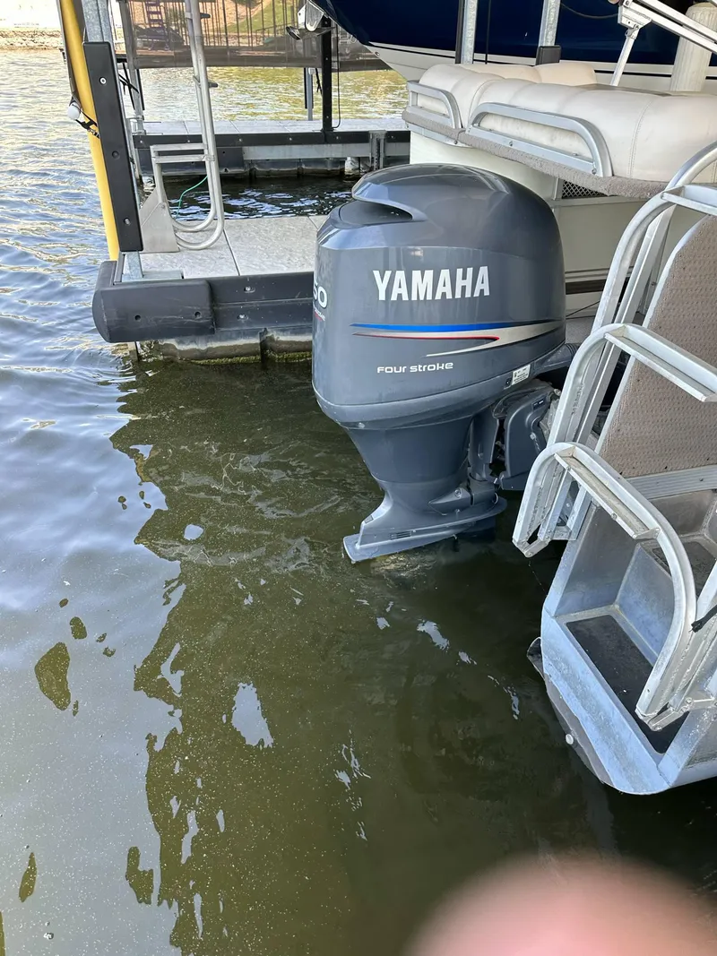 Slide: The Image of 2004 PlayCraft 2500 Ultra pontoon boat with Yamaha outboard motor on a lake. - 16