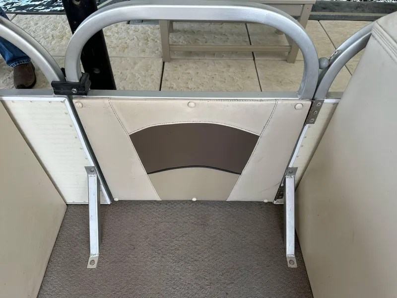 Slide: The Image of 2004 PlayCraft 2500 Ultra boat interior with beige and brown seating. - 17