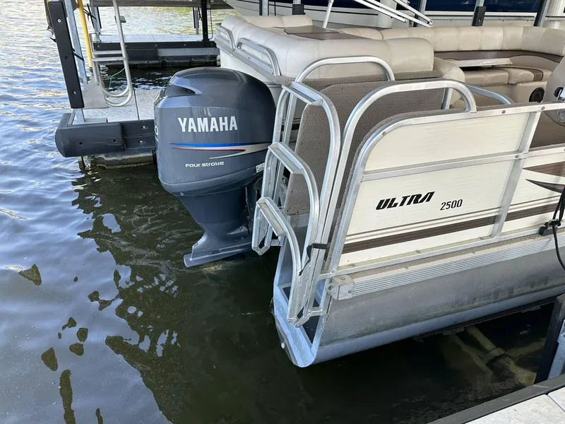 Slide: The Image of 2004 PlayCraft 2500 Ultra pontoon boat with Yamaha outboard motor docked on water. - 25