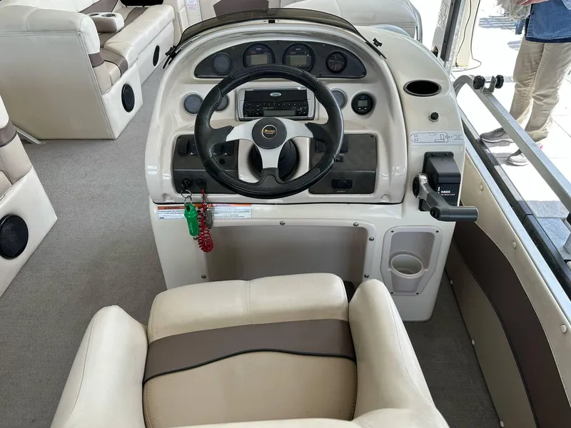 Slide: The Image of 2004 PlayCraft 2500 Ultra boat interior with steering console and seating. - 27