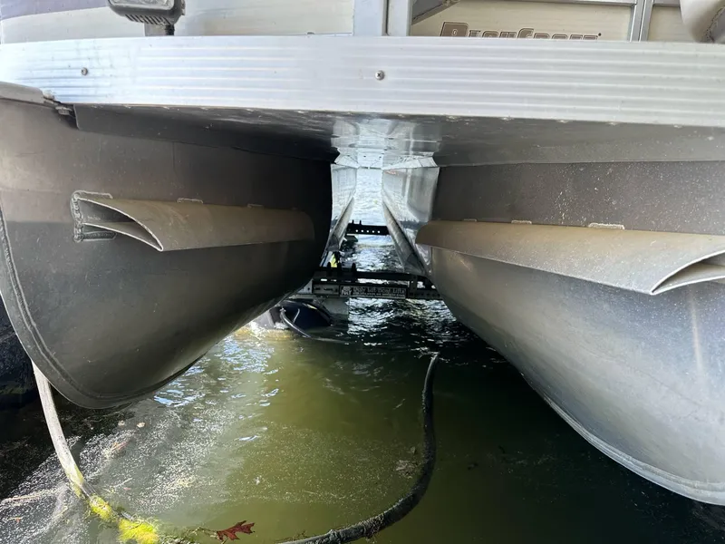 Slide: The Image of Underneath view of a 2004 PlayCraft 2500 Ultra pontoon boat on water. - 29