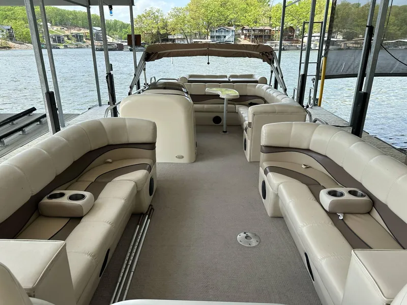 Slide: The Image of 2004 PlayCraft 2500 Ultra pontoon boat with spacious seating on a serene lake. - 34