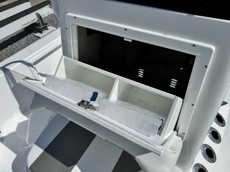 Slide: The Image of Open storage compartment on a 2025 Frontier 2104 boat, featuring organized interior space. - 12