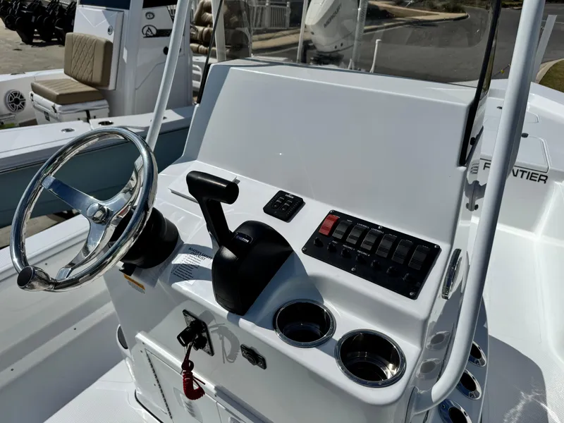 Slide: The Image of 2025 Frontier 2104 boat console with steering wheel and control panel. - 14