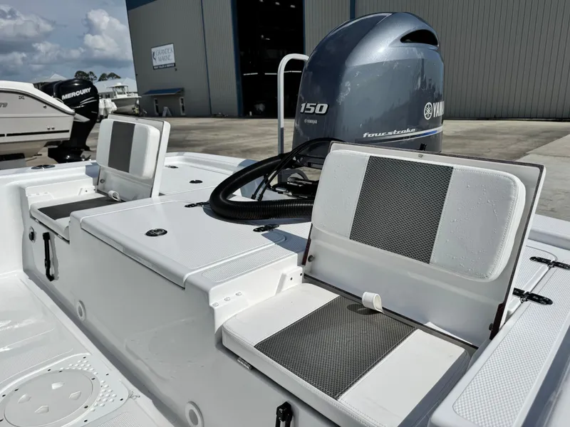 Slide: The Image of 2025 Frontier 2104 boat with Yamaha 150 engine, featuring cushioned seating and storage. - 18
