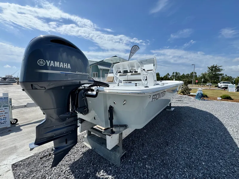 Slide: The Image of 2025 Frontier 2104 boat with Yamaha engine displayed outdoors on gravel. - 4