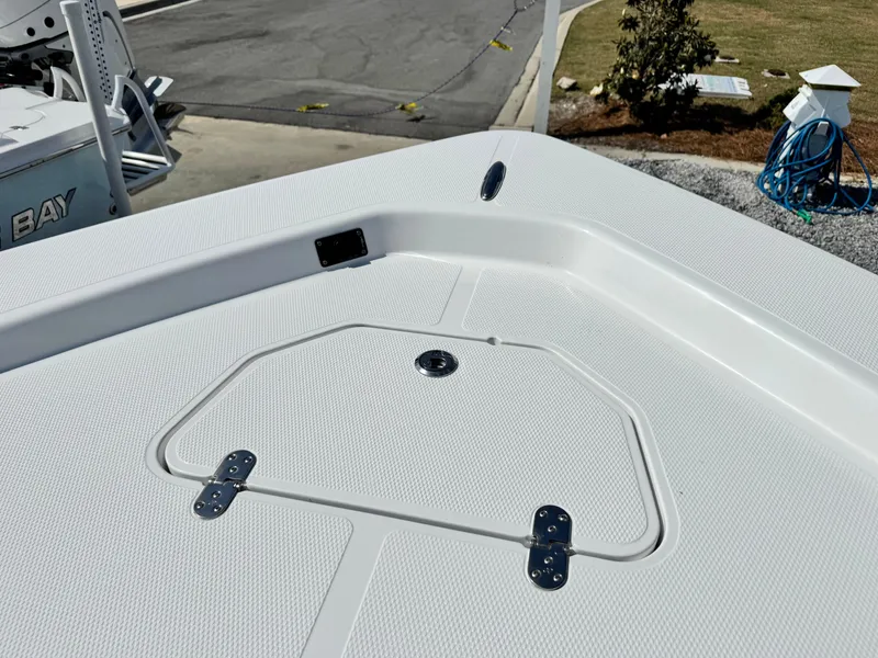 Slide: The Image of 2025 Frontier 2104 boat deck with storage hatch and textured surface. - 7
