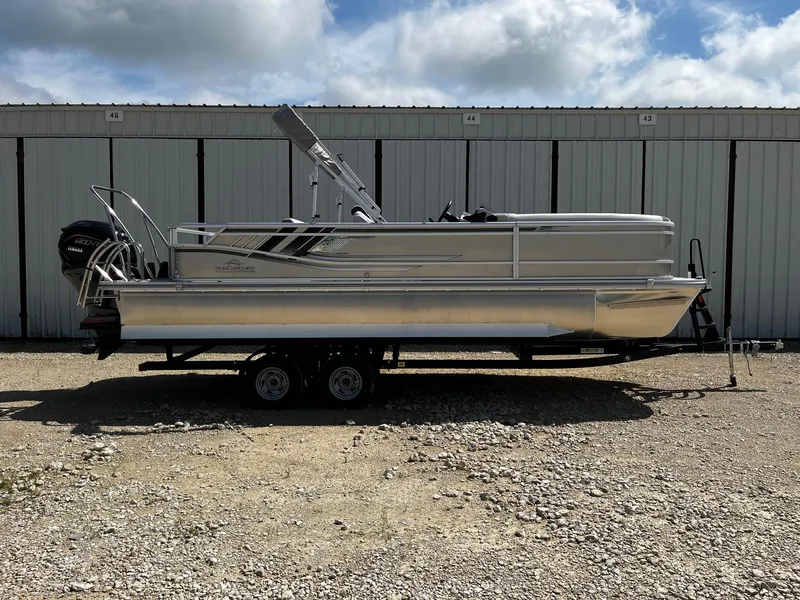 Slide: The Image of 2025 SunCatcher Select 324SL pontoon boat on trailer, parked outdoors. - 0