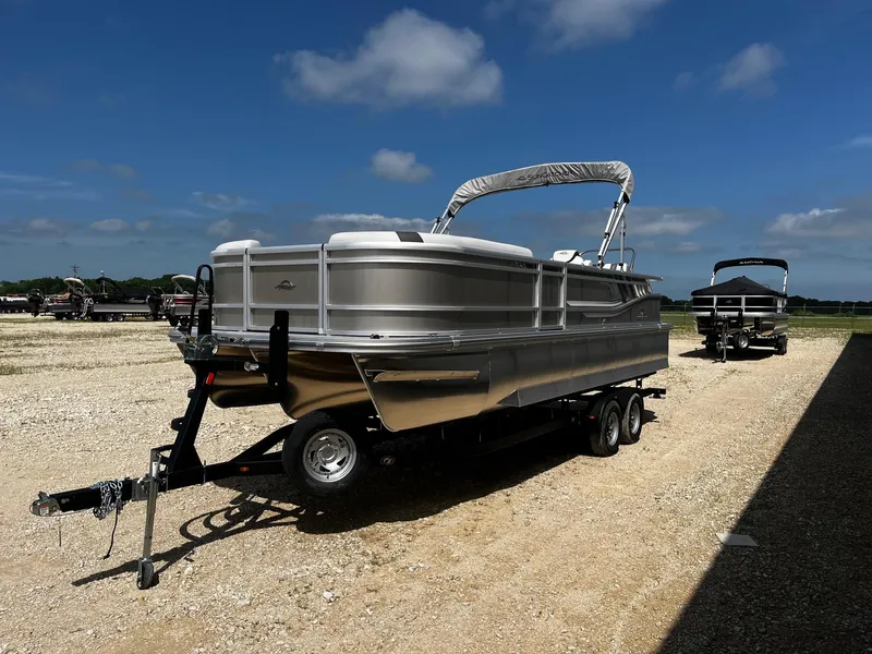 Slide: The Image of 2025 SunCatcher Select 324SL pontoon boat on trailer under clear blue sky. - 3