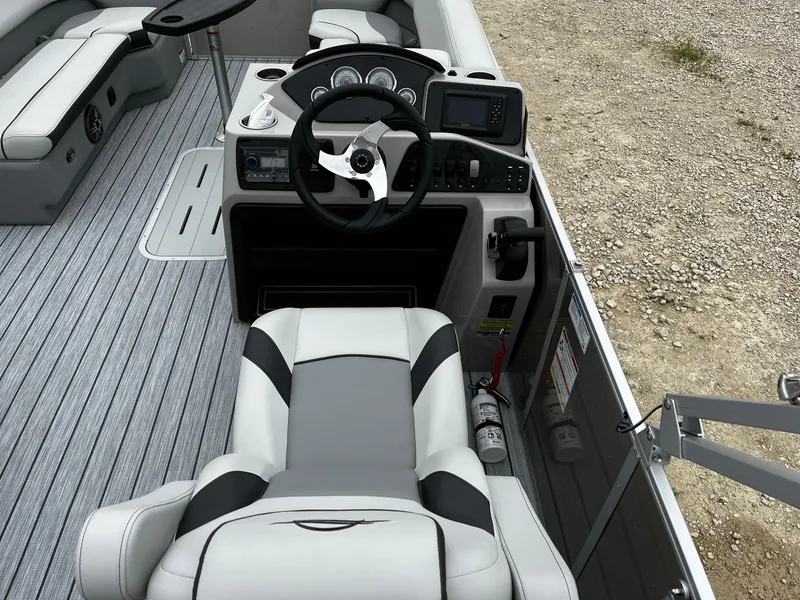 Slide: The Image of 2025 SunCatcher Select 324SL boat interior with steering console and seating. - 9