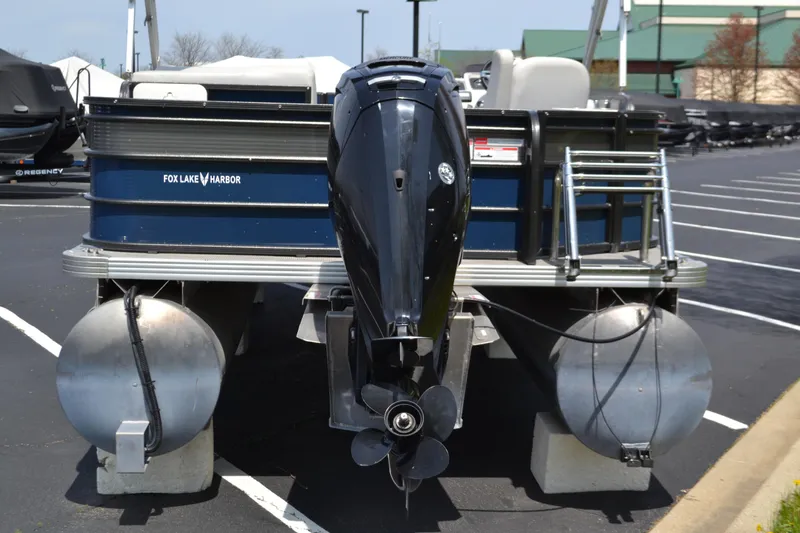Slide: The Image of 2019 Crest 220 SF pontoon boat with outboard motor in parking lot. - 2