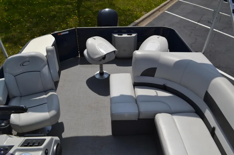 Slide: The Image of 2019 Crest 220 SF pontoon boat interior with plush seating and helm. - 4