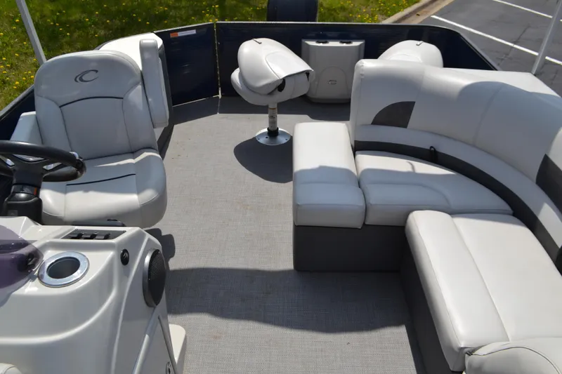 Slide: The Image of 2019 Crest 220 SF pontoon boat interior with gray seating and steering console. - 5