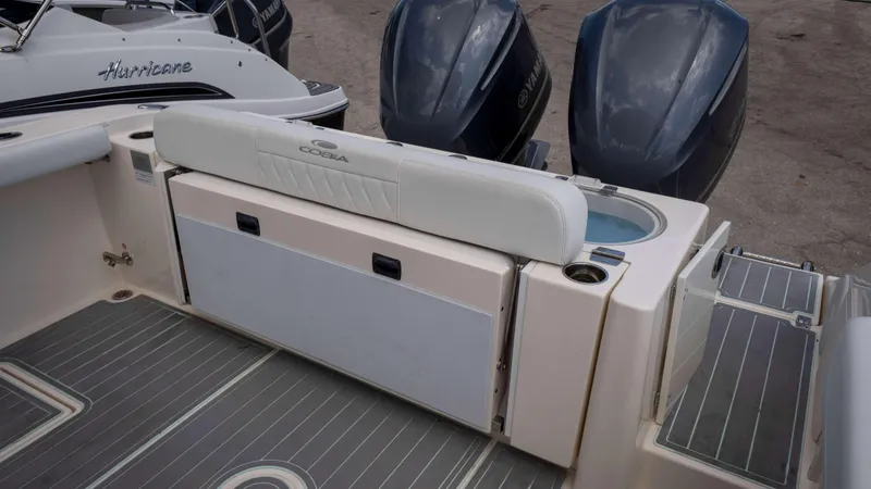 Slide: The Image of 2021 Cobia 301 CC boat with dual Yamaha engines and seating area. - 10