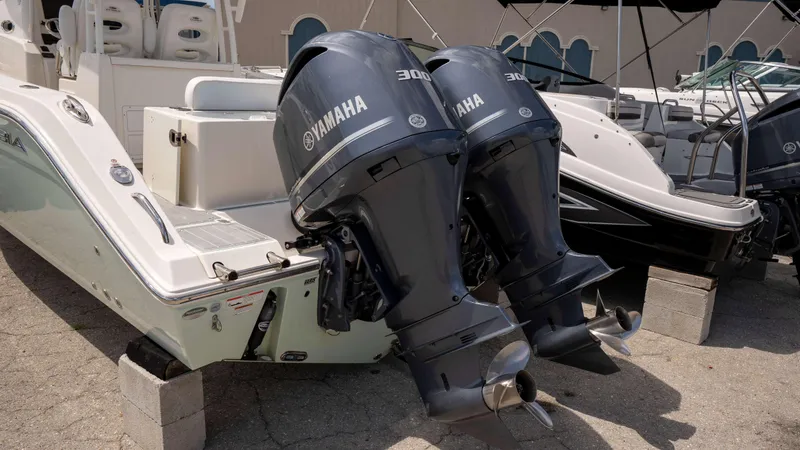 Slide: The Image of 2021 Cobia 301 CC boat with twin Yamaha outboard engines on display. - 2