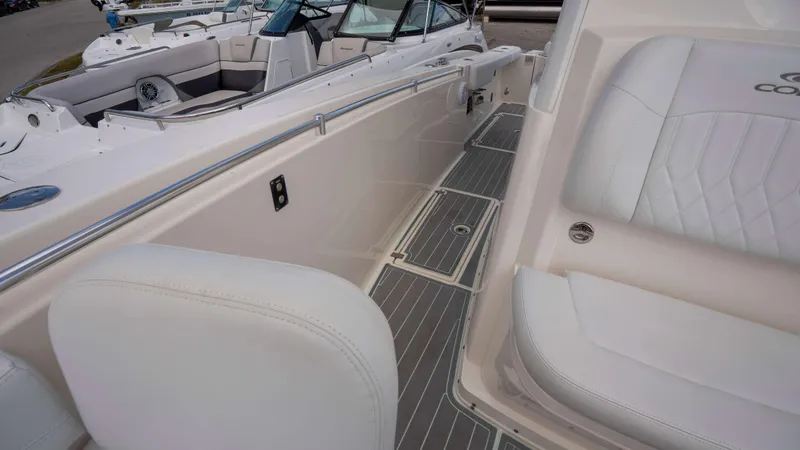 Slide: The Image of 2021 Cobia 301 CC boat interior with white seating and sleek design. - 6