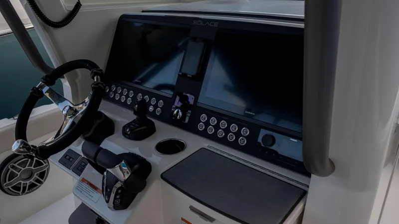 Slide: The Image of Helm of 2025 Solace 28 HCS boat with advanced navigation controls and dual screens. - 10