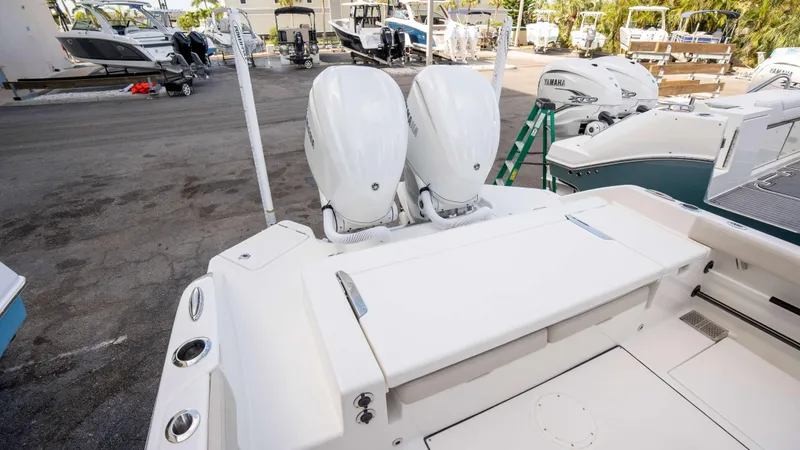 Slide: The Image of 2025 Solace 28 HCS boat with dual outboard engines in a marina setting. - 12
