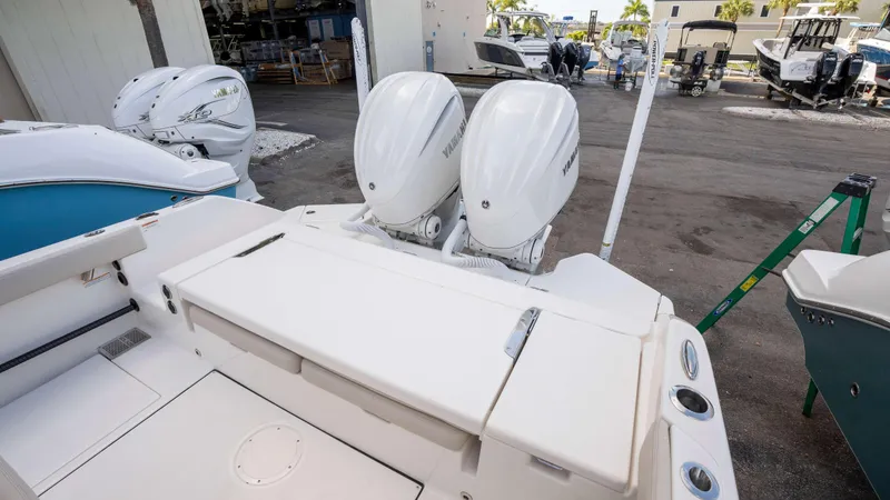 Slide: The Image of 2025 Solace 28 HCS boat with dual outboard engines in a marina setting. - 13