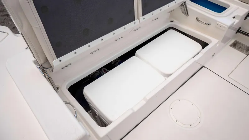 Slide: The Image of Storage compartment on 2025 Solace 28 HCS boat, featuring spacious interior and white cushions. - 17