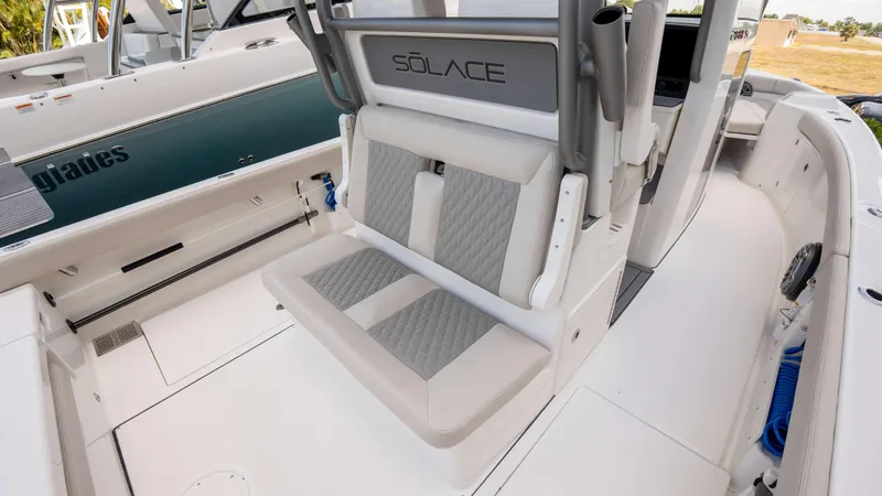 Slide: The Image of 2025 Solace 28 HCS boat interior with cushioned seating and modern design. - 19