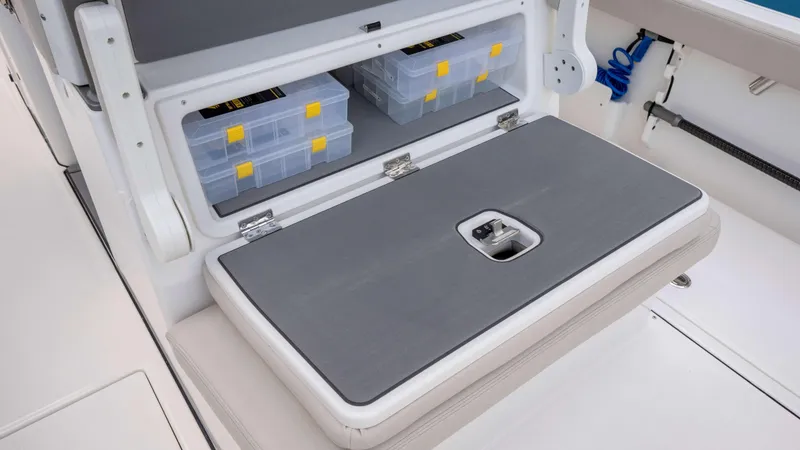 Slide: The Image of Storage compartment on 2025 Solace 28 HCS boat with organized tackle boxes. - 21