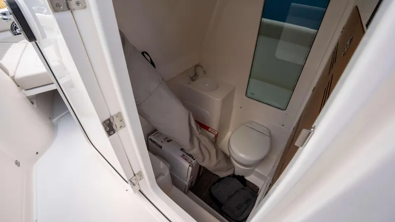 Slide: The Image of Interior of 2025 Solace 28 HCS boat featuring compact bathroom amenities. - 24