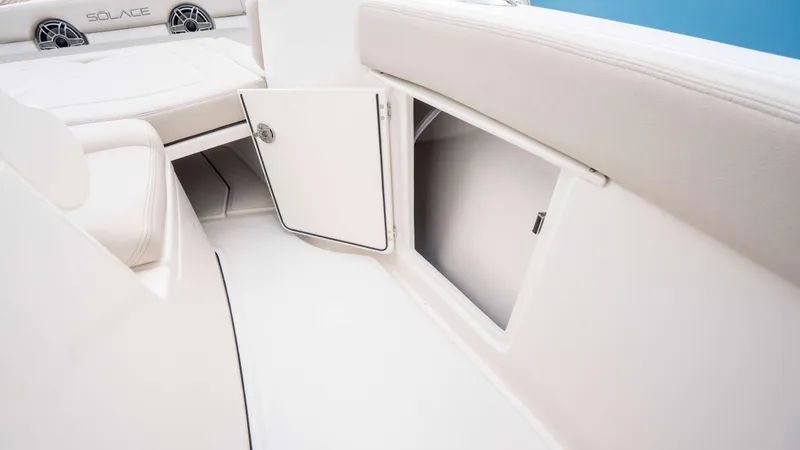 Slide: The Image of Interior view of 2025 Solace 28 HCS boat, featuring open storage compartment. - 26
