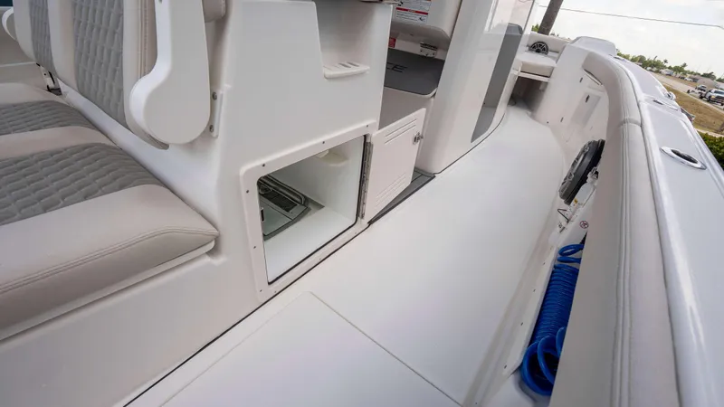 Slide: The Image of Interior view of 2025 Solace 28 HCS boat, featuring seating and storage compartments. - 28