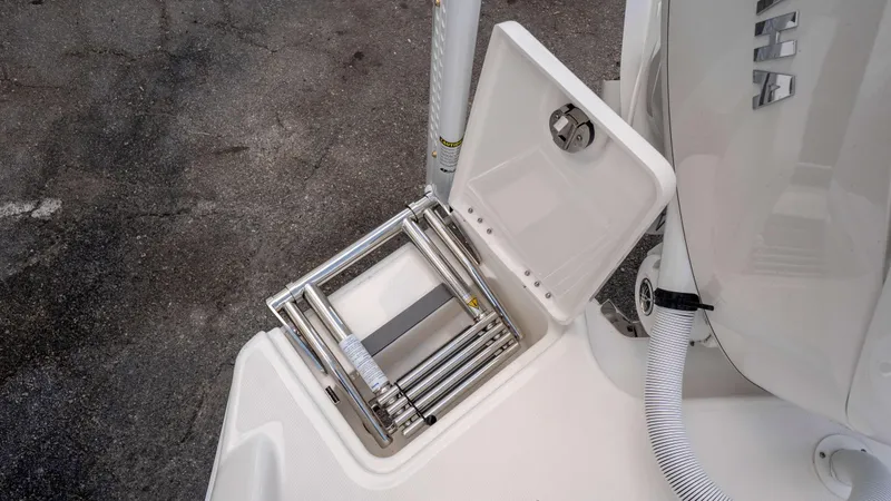 Slide: The Image of 2025 Solace 28 HCS boat with a stainless steel folding ladder and open hatch. - 30