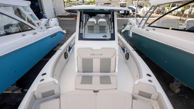 Slide: The Image of 2025 Solace 28 HCS boat, sleek design, docked among other vessels. - 4