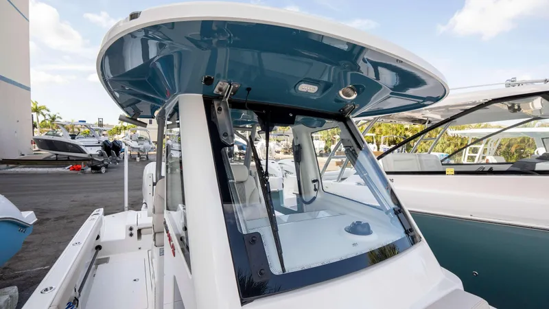 Slide: The Image of 2025 Solace 28 HCS boat with sleek design and modern features at a marina. - 7