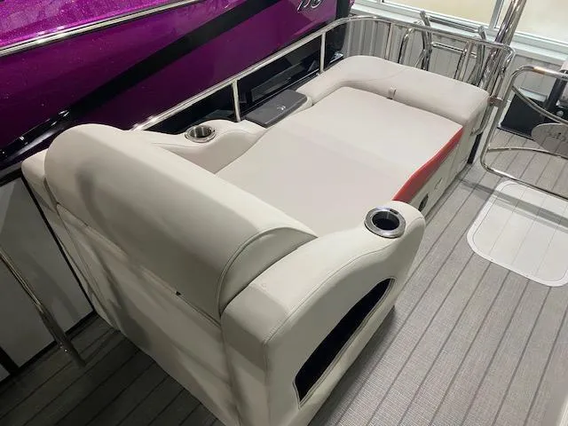 Slide: The Image of 2025 SunCatcher Elite 326 SS boat interior with plush seating and cup holders. - 11