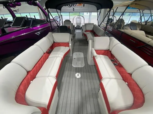 Slide: The Image of 2025 SunCatcher Elite 326 SS boat interior with red and white seating, spacious layout. - 5