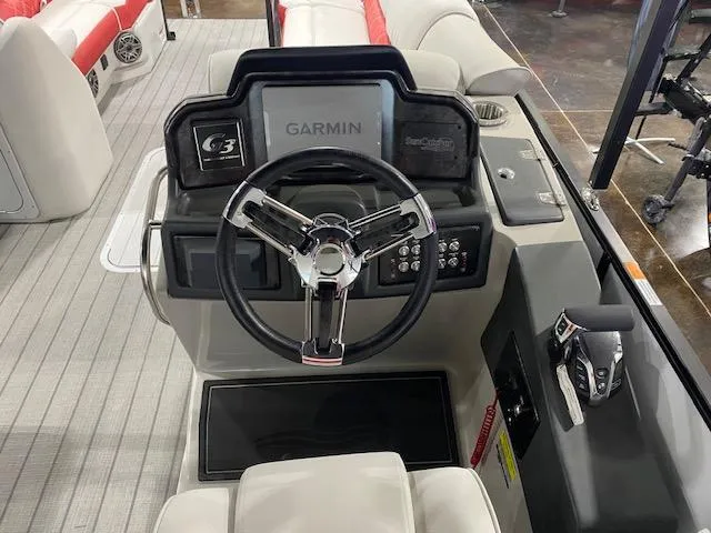 Slide: The Image of 2025 SunCatcher Elite 326 SS boat dashboard with Garmin navigation system and steering wheel. - 6