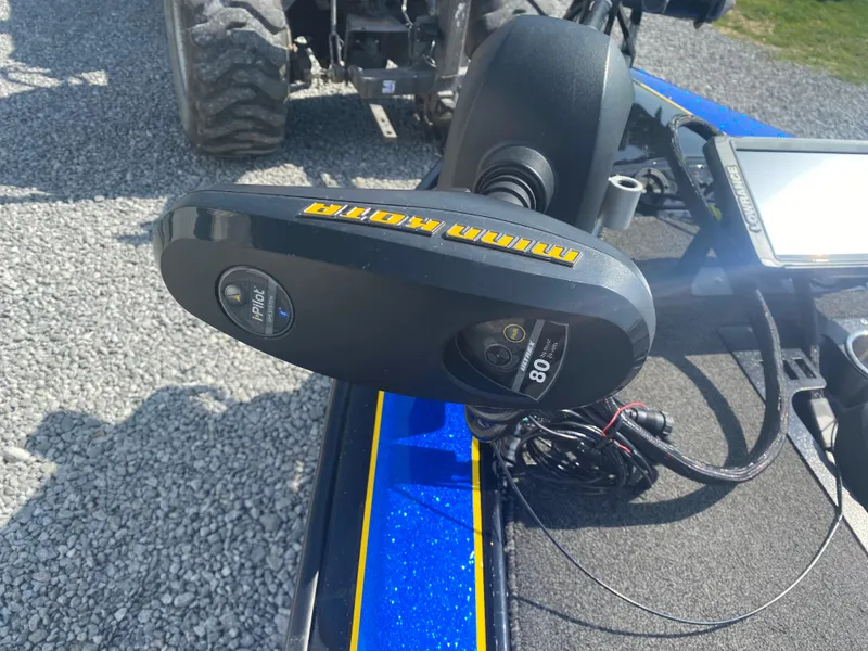 Slide: The Image of Minn Kota trolling motor on 2013 Bullet 21XRD boat, parked on gravel. - 11