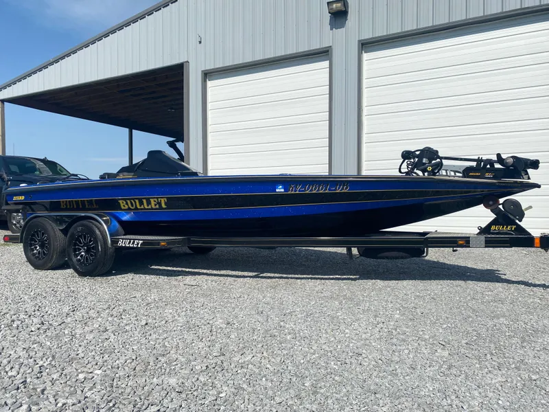 Slide: The Image of 2013 Bullet 21XRD boat on trailer, parked outside a garage. - 3
