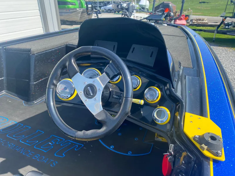 Slide: The Image of 2013 Bullet 21XRD boat dashboard with steering wheel and gauges. - 5