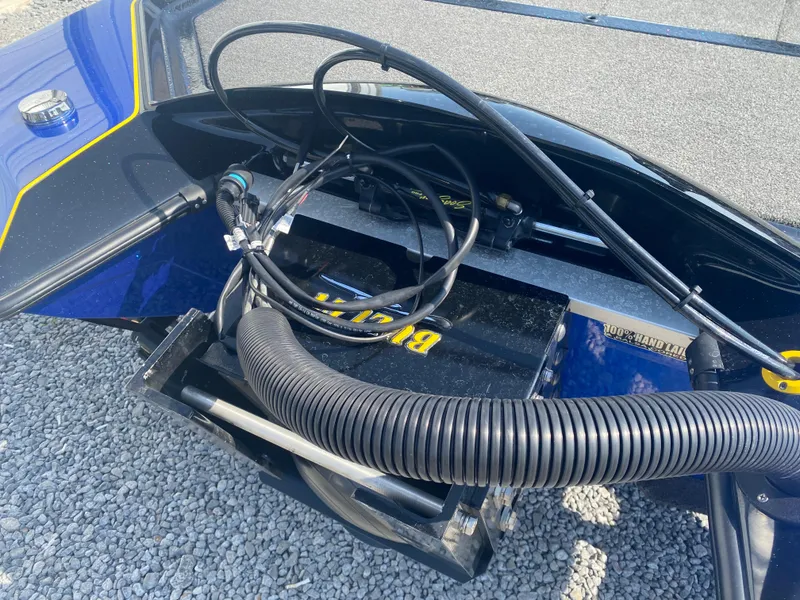 Slide: The Image of 2013 Bullet 21XRD boat with exposed wiring and tubing on gravel surface. - 7