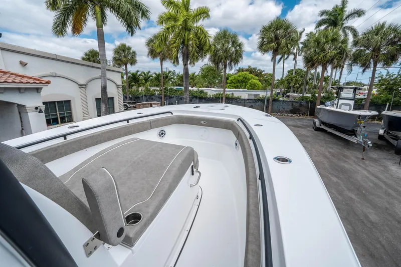 Slide: The Image of 2025 Sea Hunt Gamefish 28 CB boat, spacious deck, palm trees in background. - 24