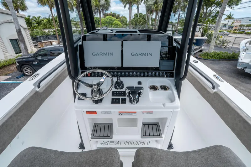 Slide: The Image of 2025 Sea Hunt Gamefish 28 CB helm with dual Garmin displays and steering wheel. - 19