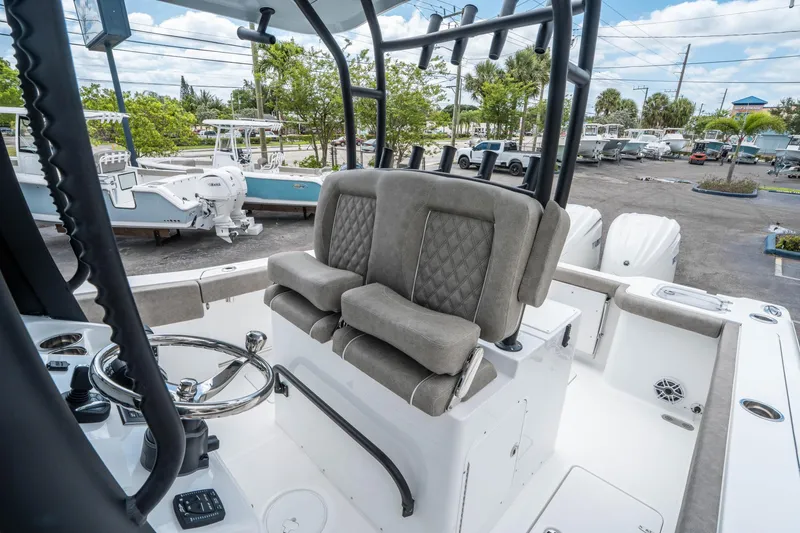 Slide: The Image of 2025 Sea Hunt Gamefish 28 CB boat interior with dual seats and steering wheel. - 20