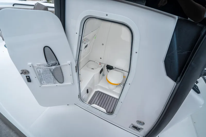 Slide: The Image of 2025 Sea Hunt Gamefish 28 CB boat interior with compact marine toilet. - 22