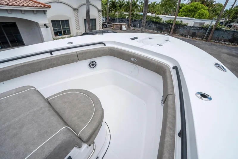 Slide: The Image of 2025 Sea Hunt Gamefish 28 CB boat interior with cushioned seating and sleek design. - 25