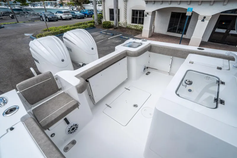 Slide: The Image of 2025 Sea Hunt Gamefish 28 CB boat interior with dual engines and seating area. - 12