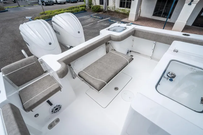 Slide: The Image of 2025 Sea Hunt Gamefish 28 CB boat interior with cushioned seating and dual outboard motors. - 13