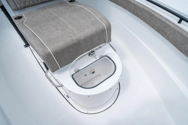 Slide: The Image of 2025 Sea Hunt Gamefish 28 CB boat interior with cushioned seating and storage compartment. - 28