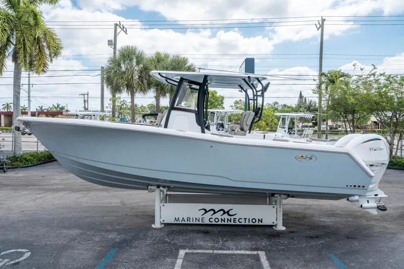 Slide: The Image of 2025 Sea Hunt Gamefish 28 CB boat displayed outdoors on a stand. - 5