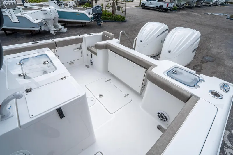 Slide: The Image of 2025 Sea Hunt Gamefish 28 CB boat interior with dual engines and seating area. - 11