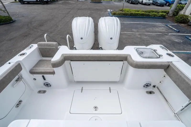 Slide: The Image of 2025 Sea Hunt Gamefish 28 CB boat interior with dual engines and seating. - 10